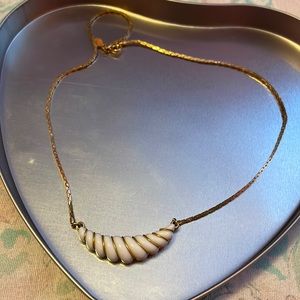 gold and white necklace